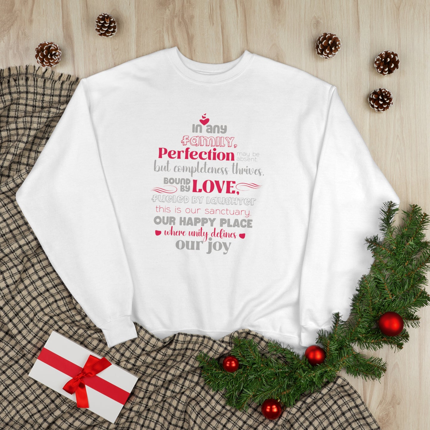 Flat lay image of Complete Comfort - Unisex EcoSmart® Crewneck Sweatshirt in White displaying typography design based on the quote 'In Any family, perfection may be absent, but completeness thrives. Bound by love, fueled by laughter – this is our sanctuar