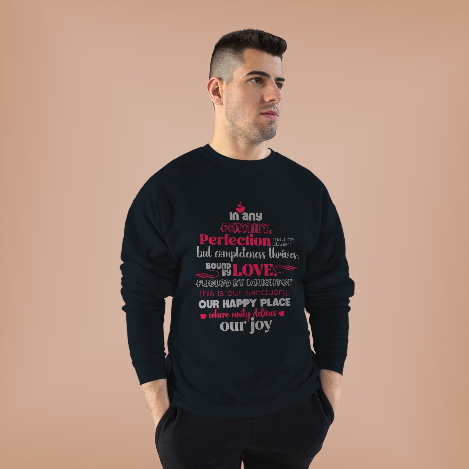 Male model showcasing Complete Comfort - Unisex EcoSmart® Crewneck Sweatshirt in Black with typography design inspired by the quote 'In Any family, perfection may be absent, but completeness thrives. Bound by love, fueled by laughter – this is our sanctua